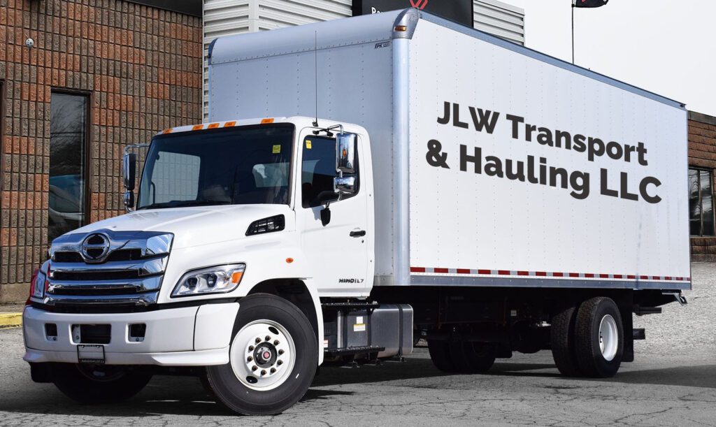 A white truck parked in front of a building.