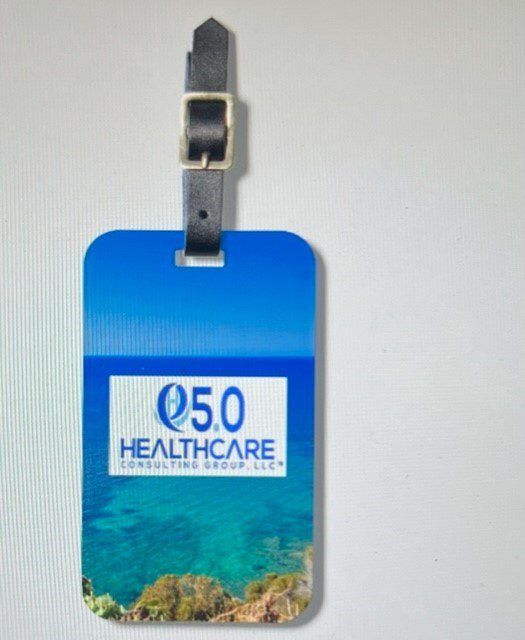 A blue and white luggage tag with the words " q 5 0 healthcare " on it.