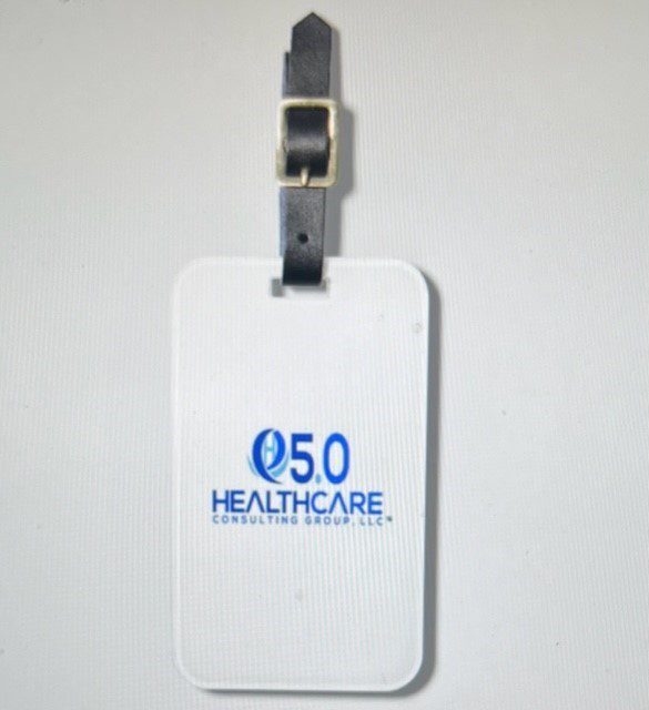A white luggage tag with the company logo on it.