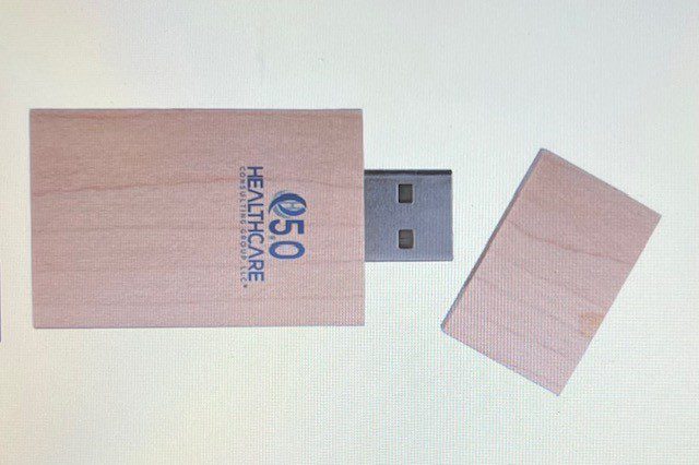 A wooden usb stick with the logo of 5 0 healthcare.