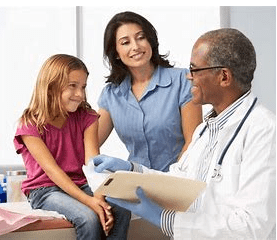 A doctor and two women with a child.