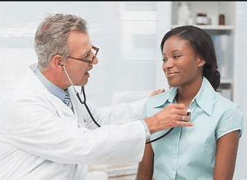 A doctor is examining the chest of a woman.